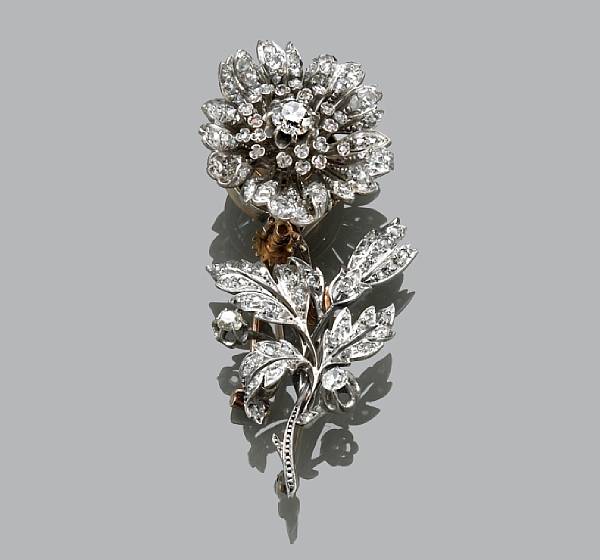 Appraisal: A diamond flower brooch with articulated movement separates into a