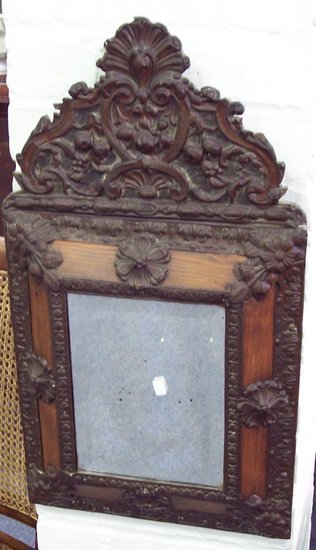 Appraisal: A Venetian style wall mirror with embossed surround and cushion