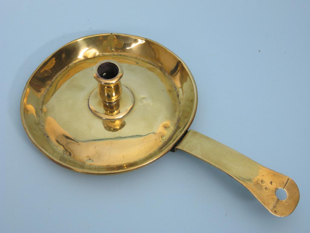 Appraisal: An early th Century brass Chamber Candlestick with flat section