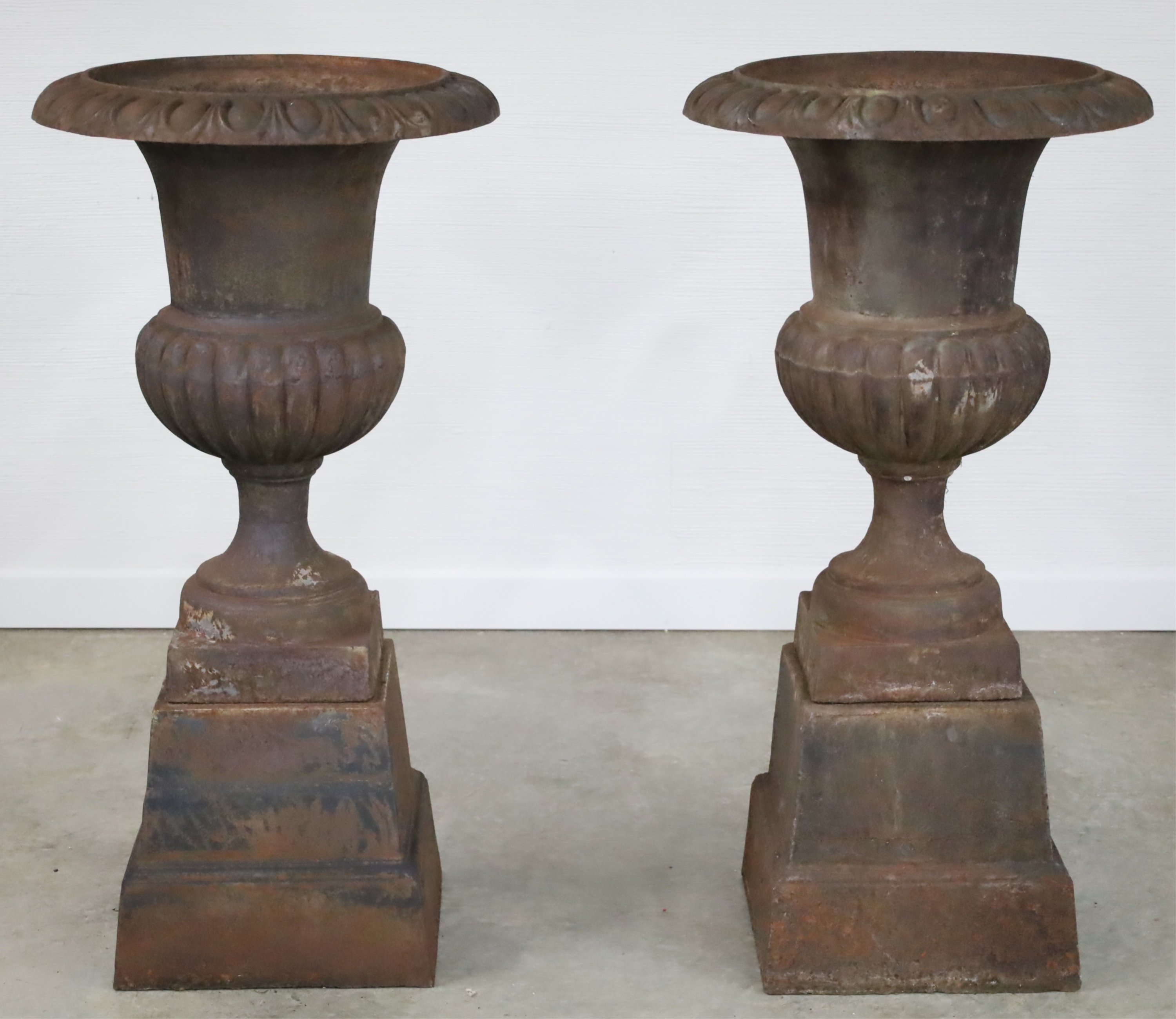 Appraisal: PAIR OF CLASSICAL CAST IRON STYLE URNS ON STANDS Pair