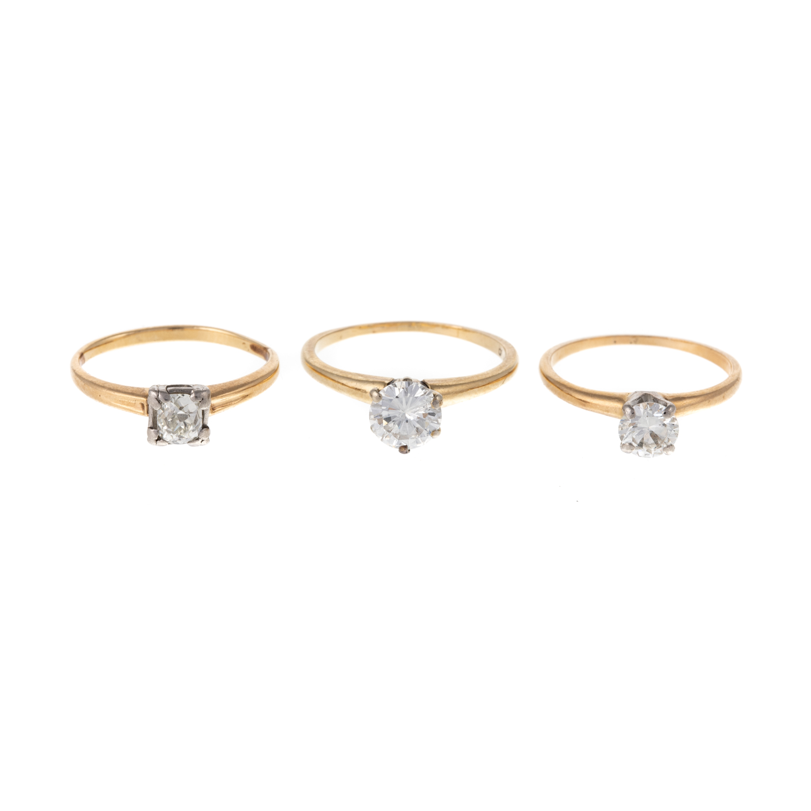 Appraisal: A TRIO OF DIAMOND SOLITAIRE RINGS IN GOLD K yellow