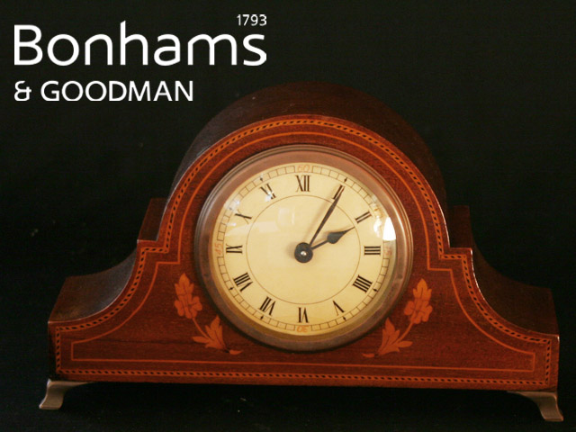 Appraisal: An Edwardian mantle clock of arched form circular dial with