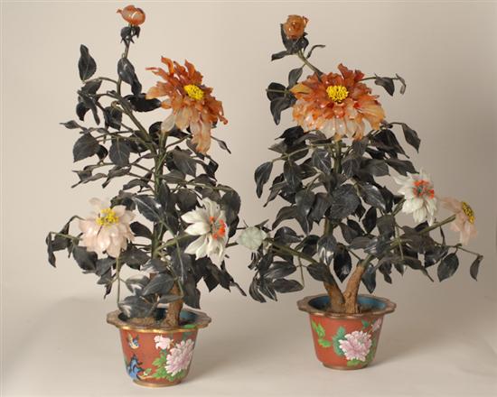 Appraisal: A Pair of Mixed Stone Floral Arrangements in matching weighted