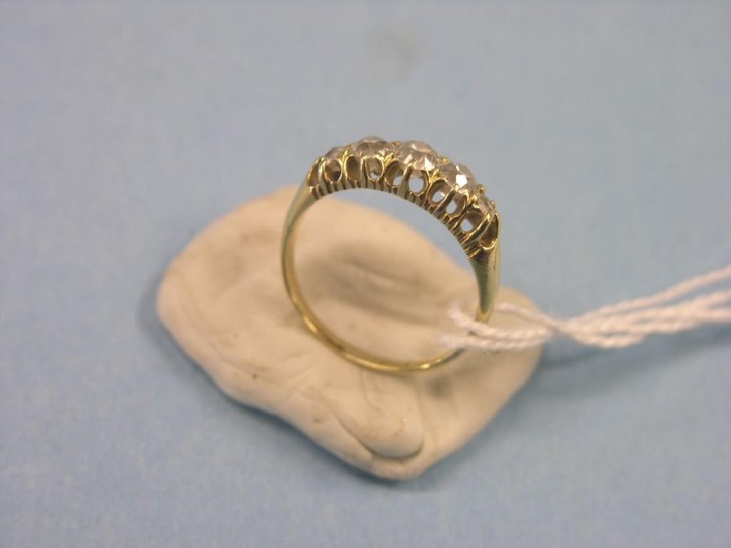 Appraisal: A gold and diamond ring five graduated diamonds within claw