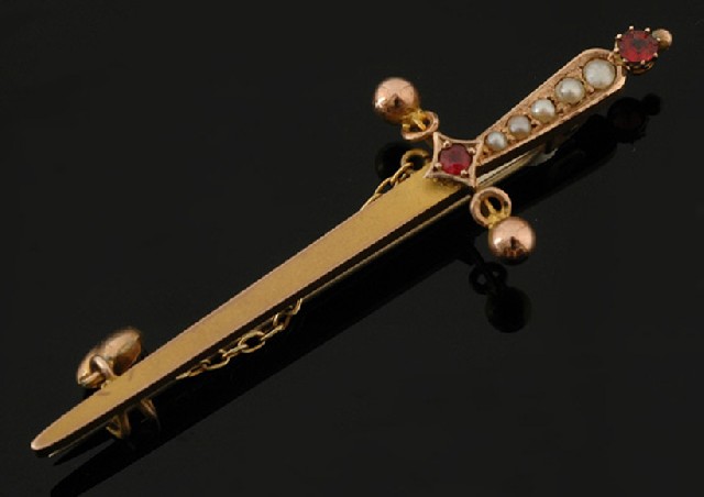 Appraisal: An Antique sword brooch Set to the handle with seed