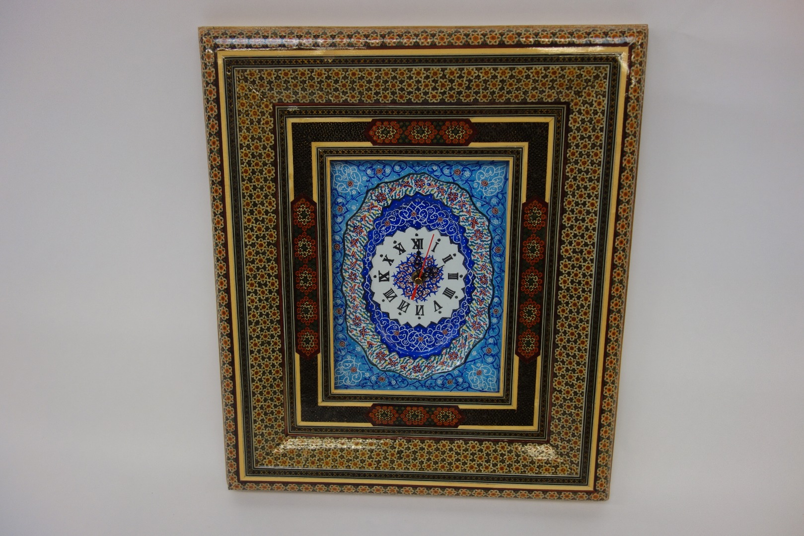 Appraisal: A modern Persian wall timepiece with foliate decorated enamel dial