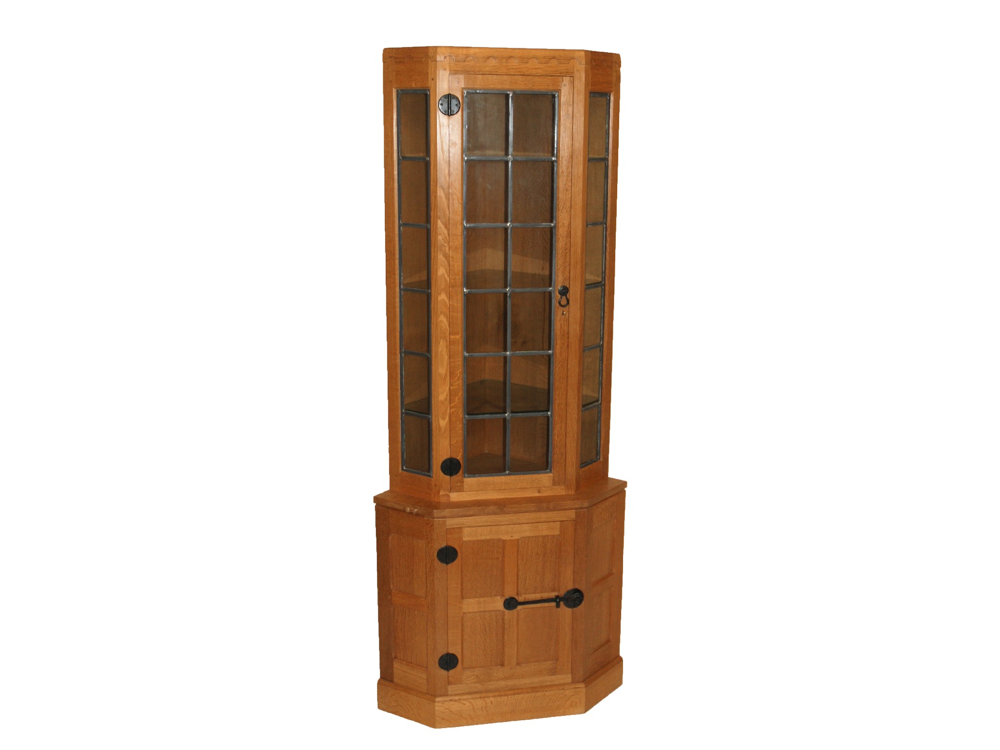 Appraisal: ROBERT 'MOUSEMAN' THOMPSON An oak corner display cabinetthe leaded astragal