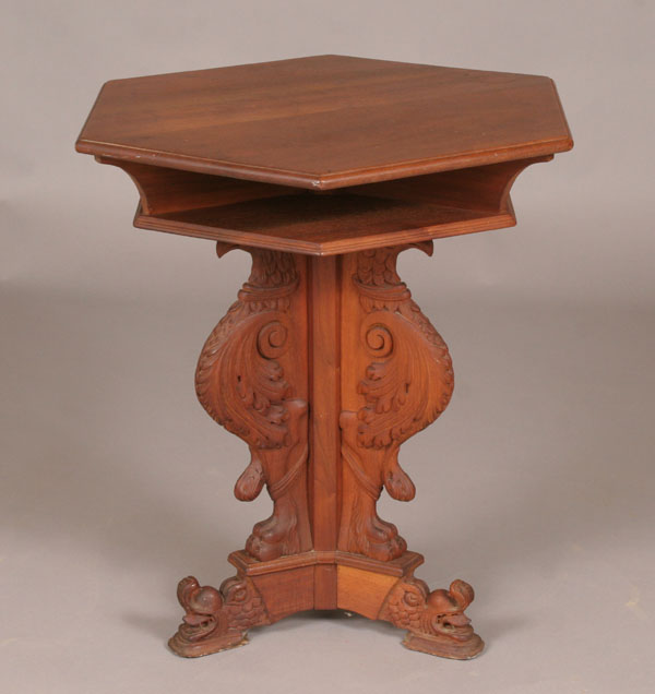 Appraisal: Hexagonal top wooden stand table carved griffin base porpoise head