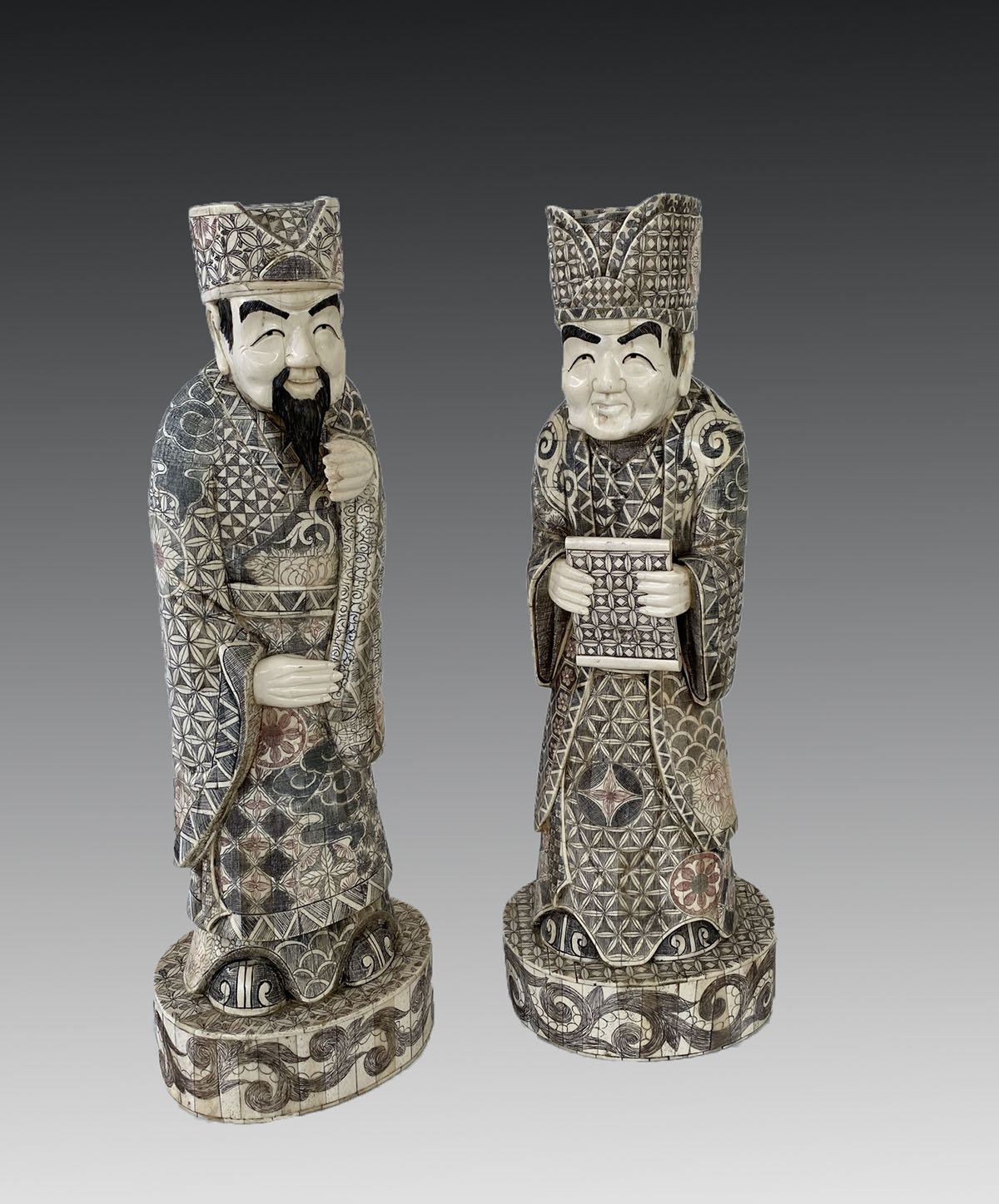 Appraisal: PAIR OF BONE CLAD CHINESE FIGURES Having incised and painted