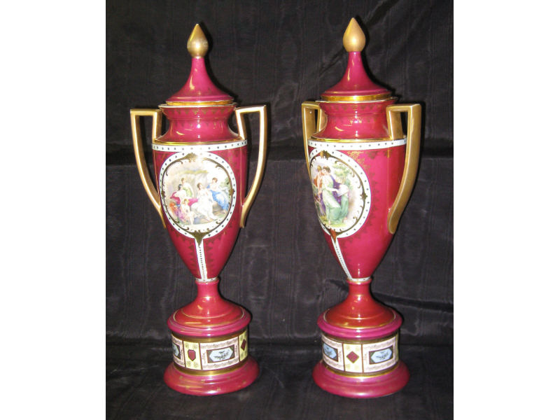 Appraisal: PAIR VIENNESE STYLE PORCELAIN URNS Each red grounded footed and