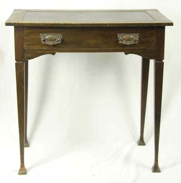 Appraisal: An Art Nouveau oak side table with frieze drawer on