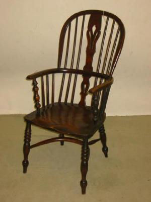 Appraisal: AN ASH AND ELM WINDSOR ARMCHAIR of high hoop back