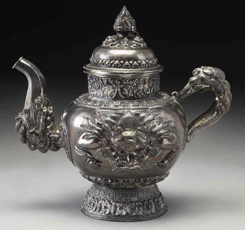 Appraisal: Chinese Qing silver tea pot depicting lions andflowers ''H x