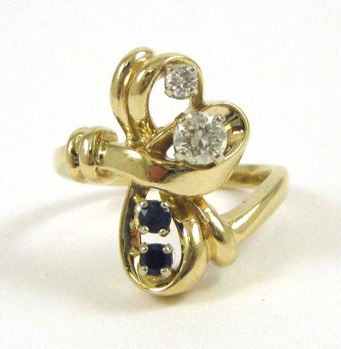 Appraisal: SAPPHIRE DIAMOND AND FOURTEEN KARAT GOLD RING set with two