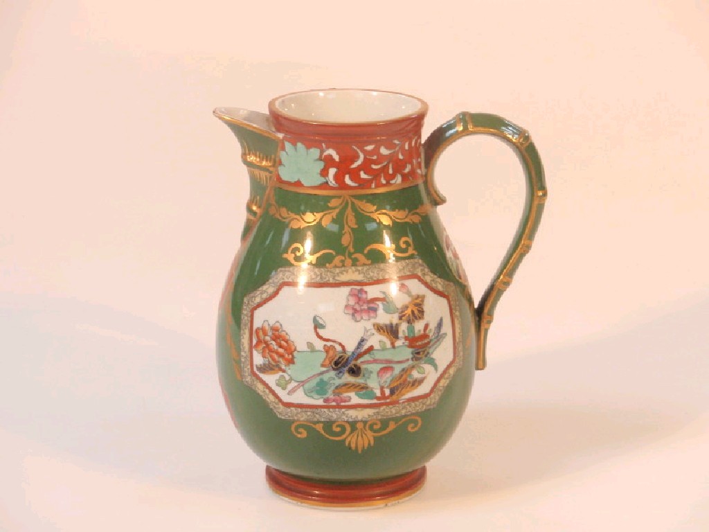 Appraisal: An Ashworth ironstone baluster jug with a bamboo moulded handle