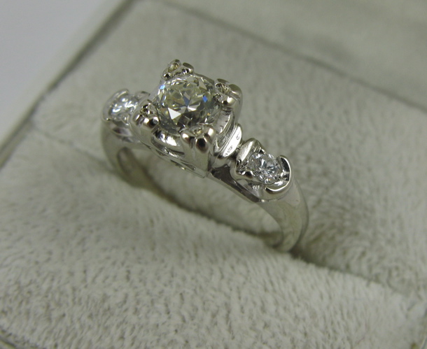 Appraisal: DIAMOND AND K WHITE GOLD RING centering a round-cut diamond