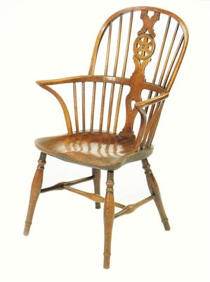 Appraisal: An early th century fruitwood wheelback Windsor armchair with an