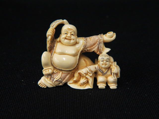 Appraisal: Carved Ivory Netsuke of Hotei god of happiness holding a