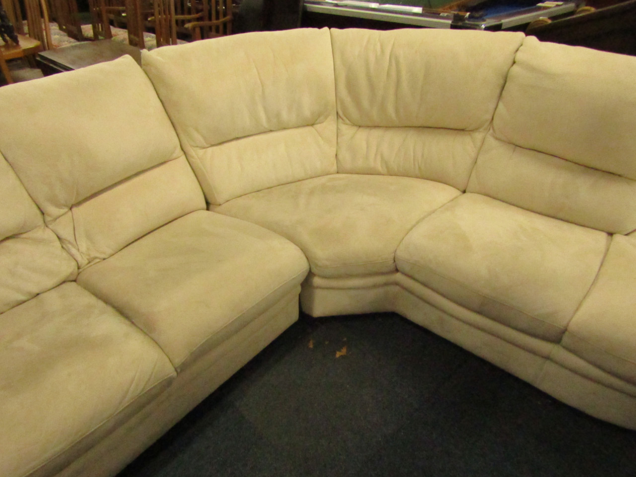 Appraisal: A four seater corner sofa upholstered in faux cream suede