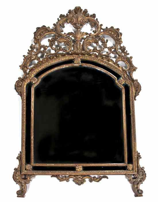 Appraisal: A Baroque Style Giltwood Mirror the domed plate surmounted with