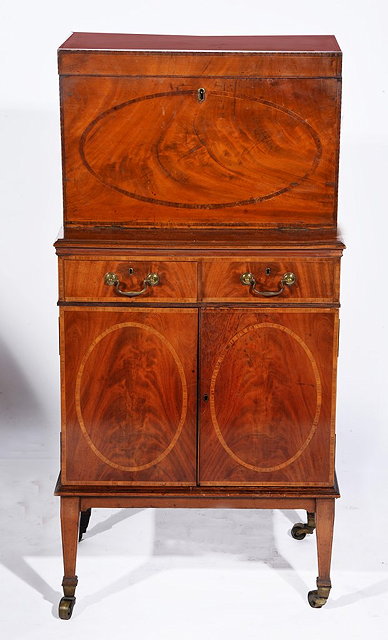 Appraisal: AN EDWARDIAN MAHOGANY AND INLAID CONVERTED DRINKS CABINET fitted drawers