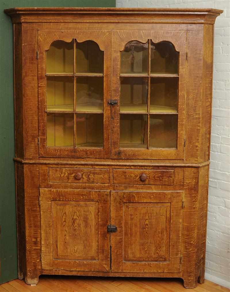 Appraisal: LATE FEDERAL OAK-GRAINED TWO-PART CORNER CABINET The cornice with canted