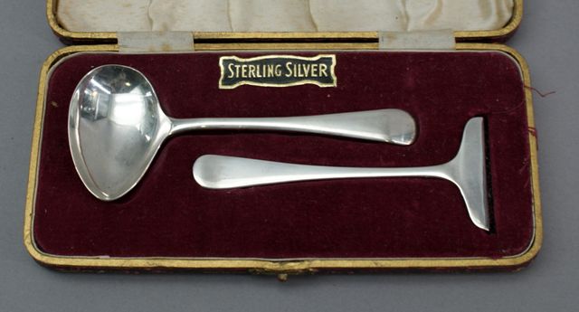 Appraisal: A cased sterling silver tongue scraper and ladle set Sheffield