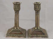 Appraisal: A pair of white metal untested cluster column candlesticks weighted