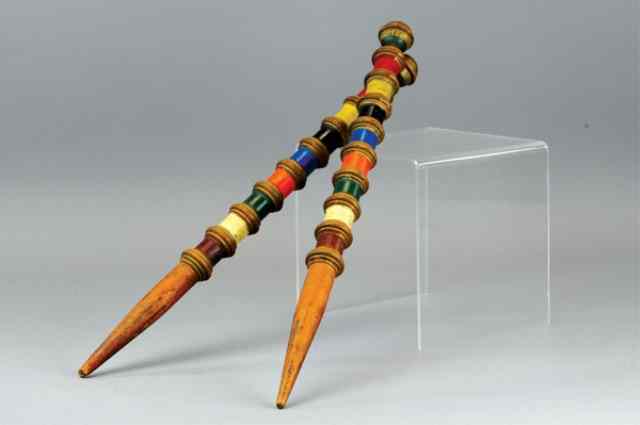 Appraisal: TWO DECORATED CROQUETTE POLES Hand painted wooden stakes these make