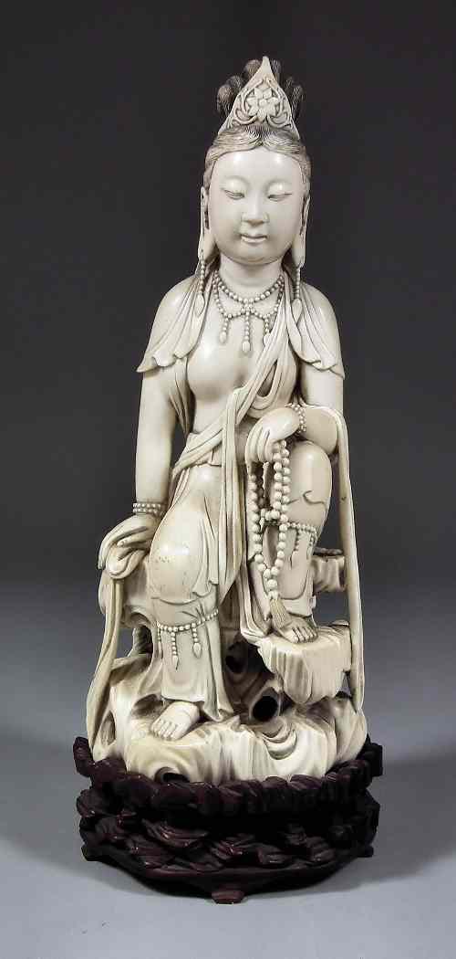 Appraisal: A South East Asian carved ivory figure of an Acolyte