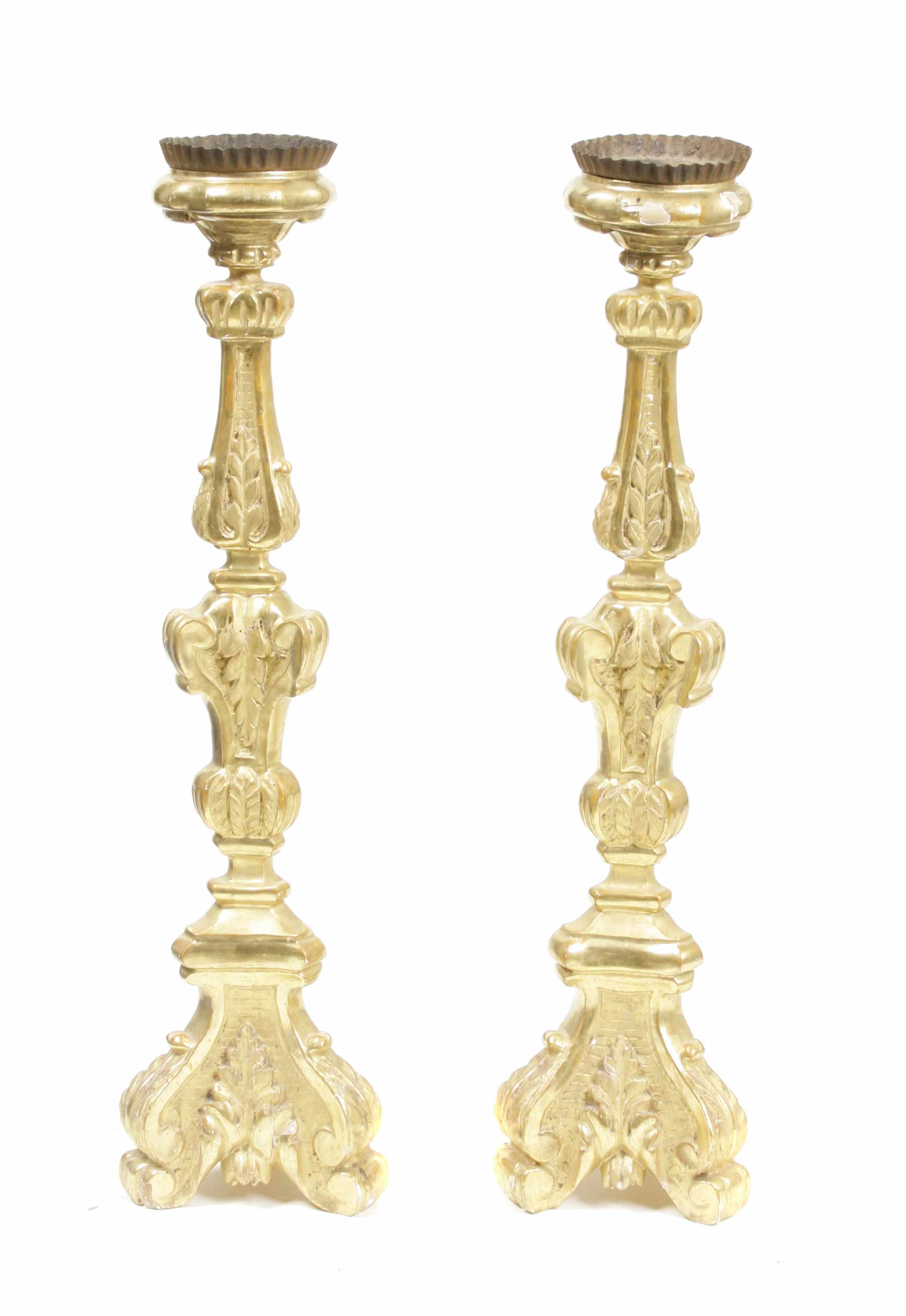 Appraisal: A pair of Italian Baroque style parcel giltwood pricket sticks