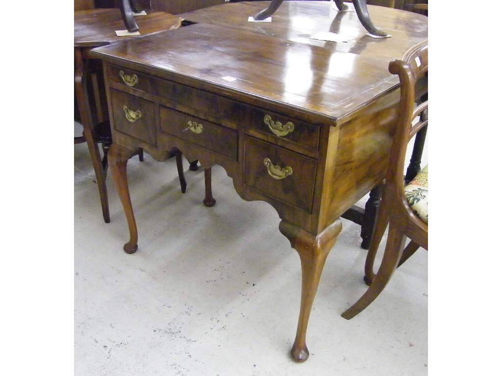 Appraisal: Georgian style walnut lowboy the crossbanded and strung top over