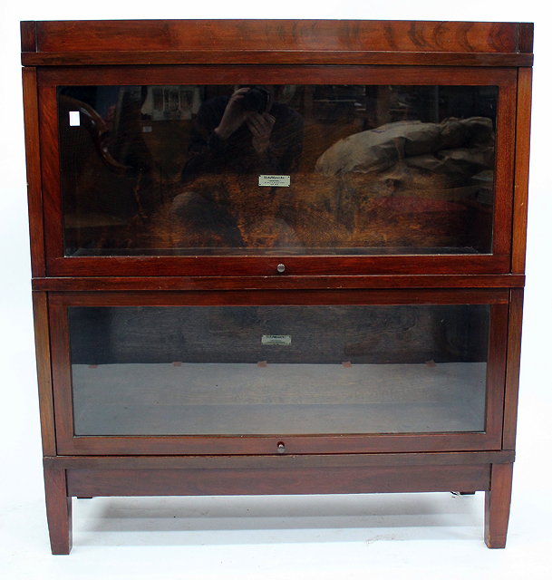 Appraisal: A MAHOGANY TWO SECTION GLOBE WERNICKE TYPE BOOKCASE with glazed