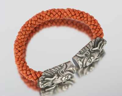 Appraisal: A Tibetan Silver and Coral Bracelet Coral bead twist design