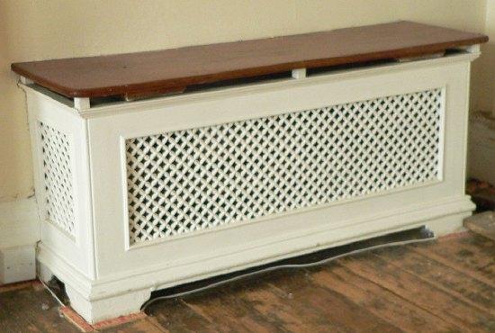 Appraisal: A single pierced cast radiator surround with pierced ends and