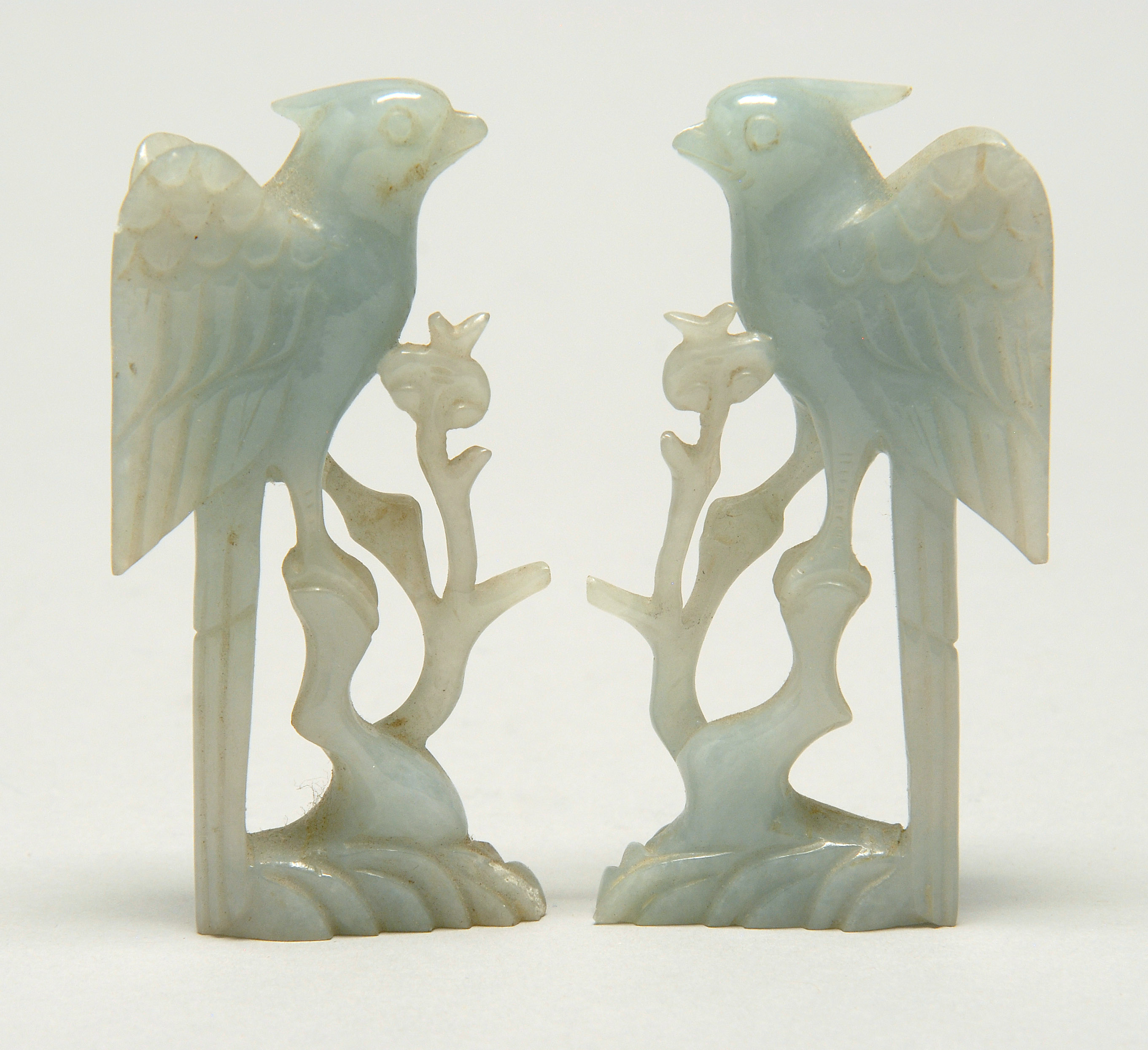 Appraisal: PAIR OF PALE GREEN JADE BIRD FIGURES Early th CenturyPerched