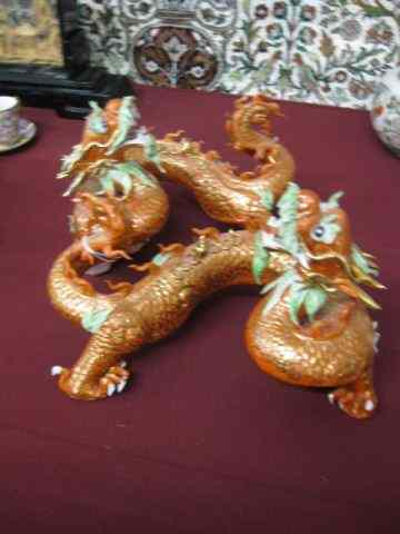 Appraisal: Pair of Porcelain Figurines of Dragons fancy goldwork on orange