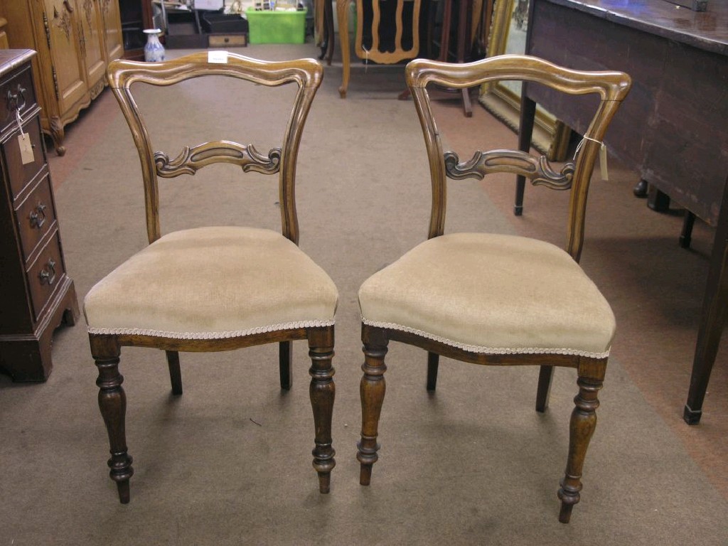 Appraisal: A pair of Victorian rosewood dining chairs with carved bar-backs