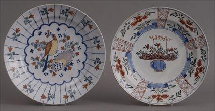 Appraisal: TWO DUTCH POLYCHROME CHARGERS The one with bird amidst flowers