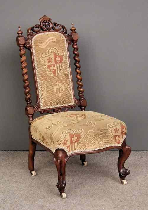 Appraisal: A Victorian walnut nursing chair with pierced cresting and spiral