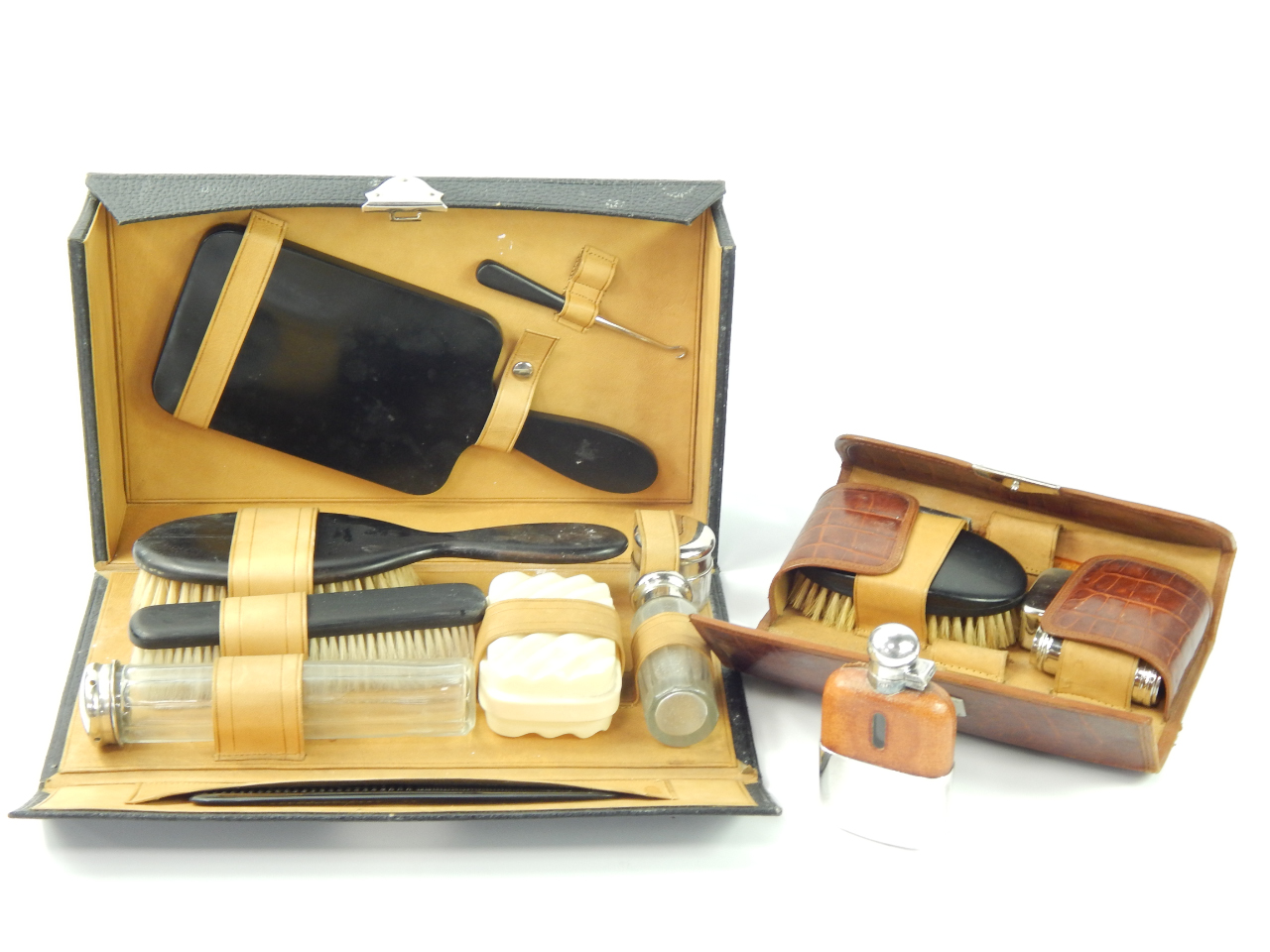 Appraisal: A black leather cased lady's travelling toilet set together with