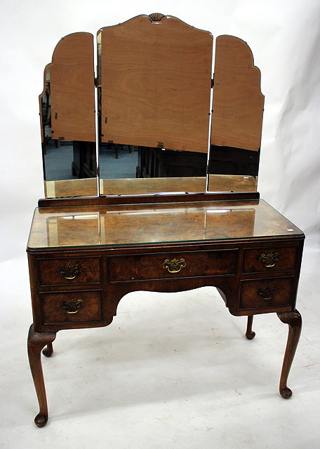 Appraisal: A WALNUT DRESSING TABLE with triple mirror over a table