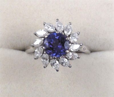 Appraisal: A tanzanite and diamond cluster ring The circular cut tanzanite