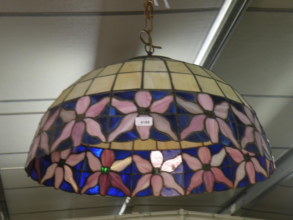 Appraisal: A large Tiffany style stained glass and leaded lampshade