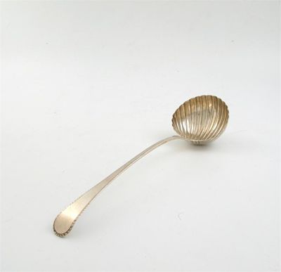 Appraisal: A George III feather edge soup ladle with a fluted