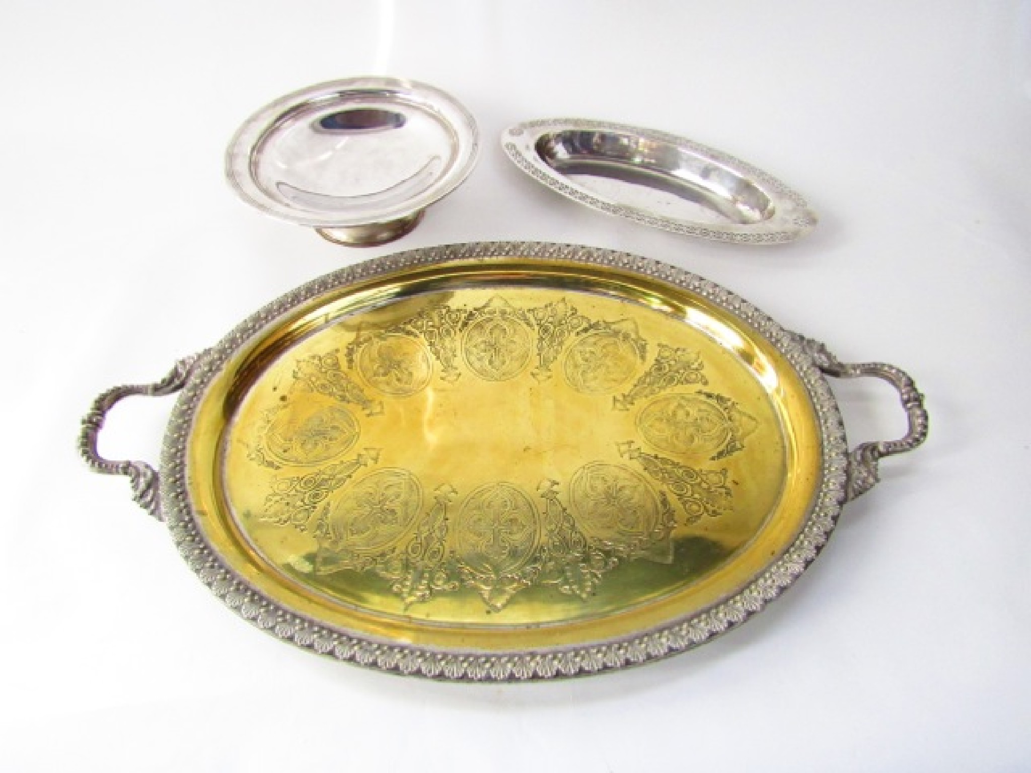 Appraisal: A substantial silver plated on brass drinks tray with central