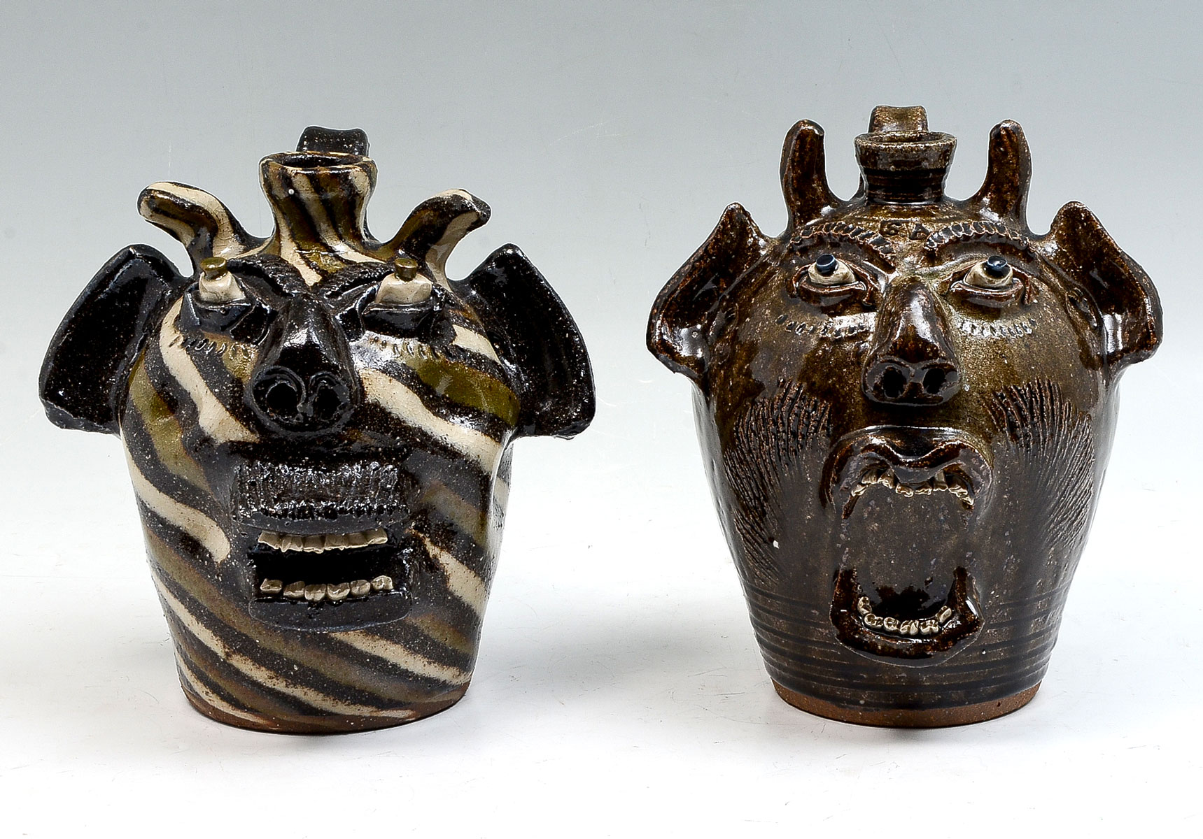 Appraisal: NORTH CAROLINA ''STEVE ABEE'' POTTERY FACE JUGS Demonic art pottery