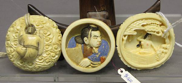 Appraisal: Three ivory one-part manju The first of a scholar amid