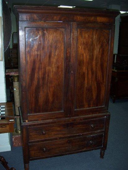 Appraisal: A th Century mahogany linen press the panel doors enclosing