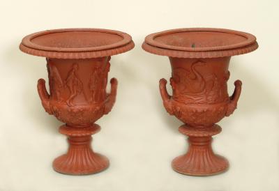 Appraisal: TWO CAST IRON GARDEN URNS of campagna form with egg